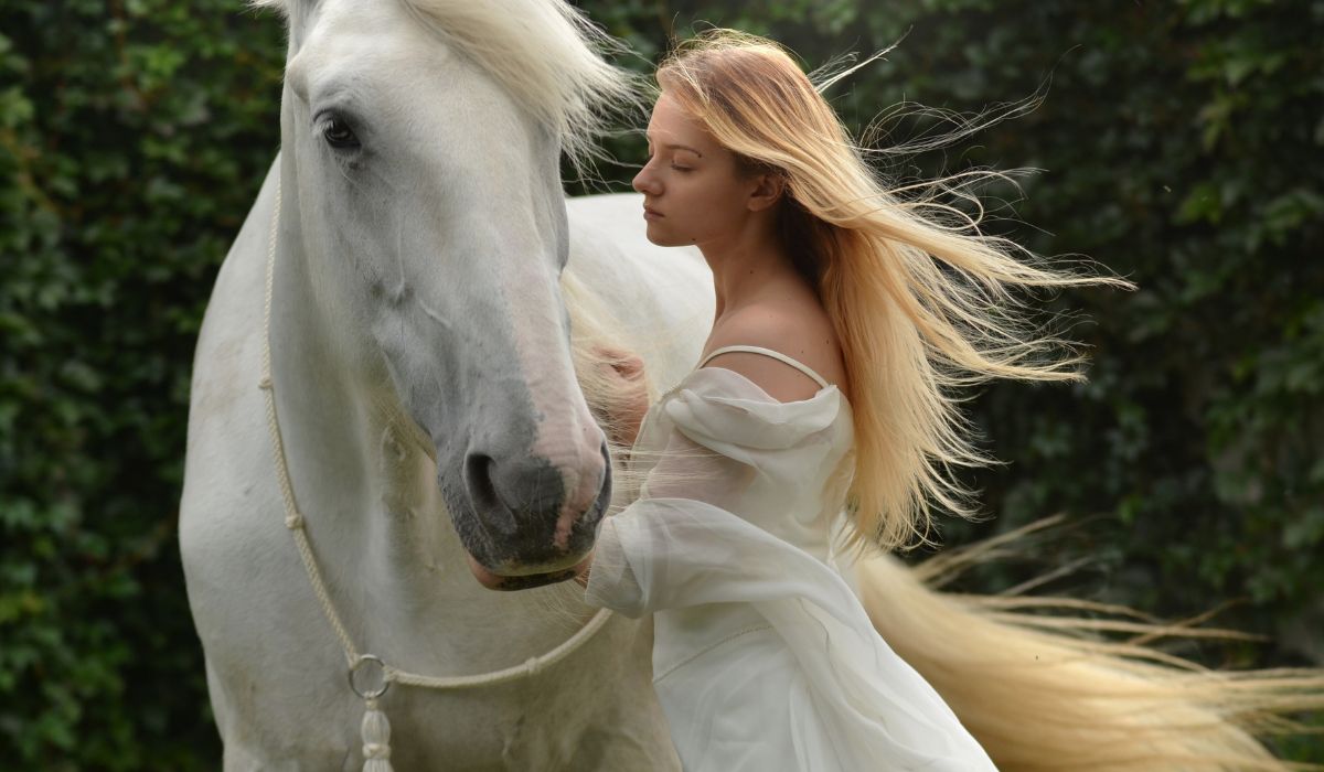 magische Pferdeshow- Cavalluna: Schimmel mit Frau im weißen Kleid