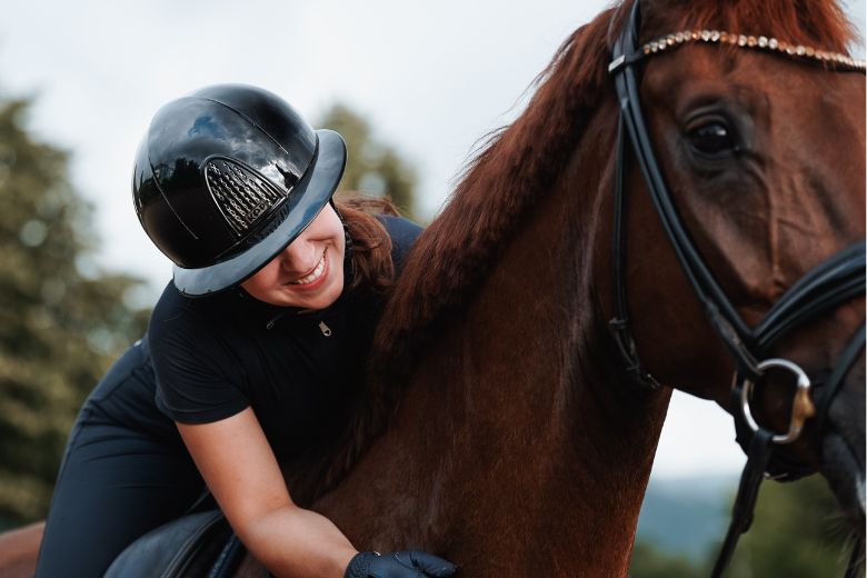Reitbeteiligung: Frau sitzt auf einem Pferd